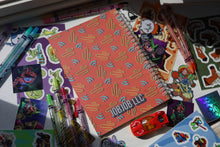 Load image into Gallery viewer, JobJob Reusable Sticker BookBook open on a desk surrounded by colorful stickers and pens — reusable waxy sticker organizer by JobJobLLC